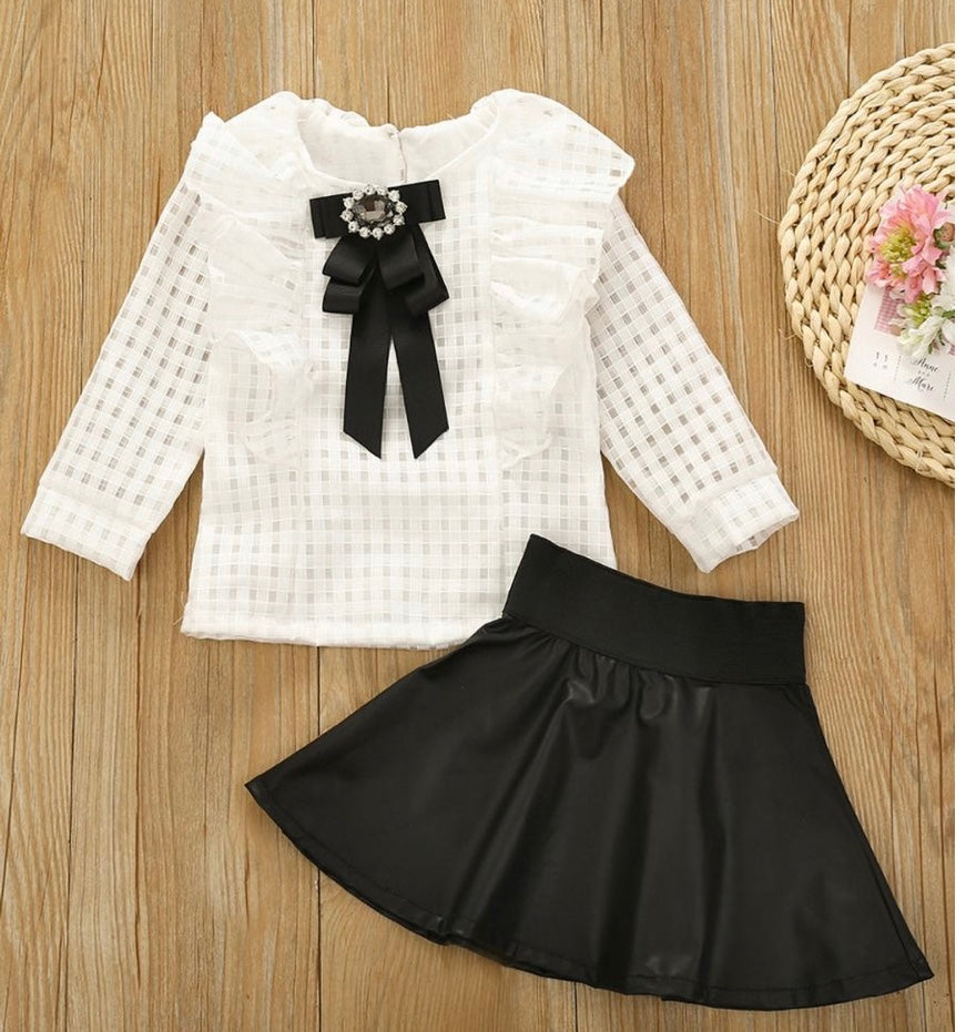 White ruffle top with black mini skirt