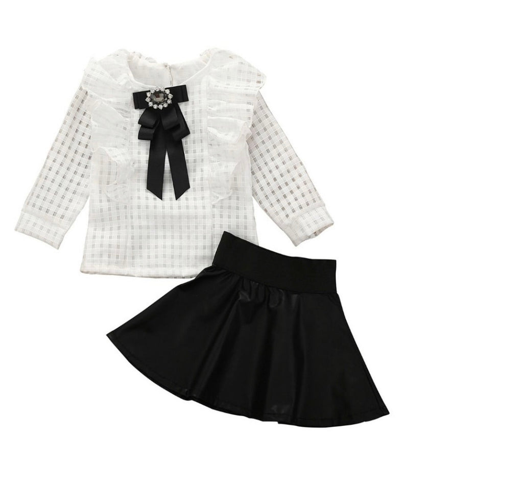 White ruffle top with black mini skirt